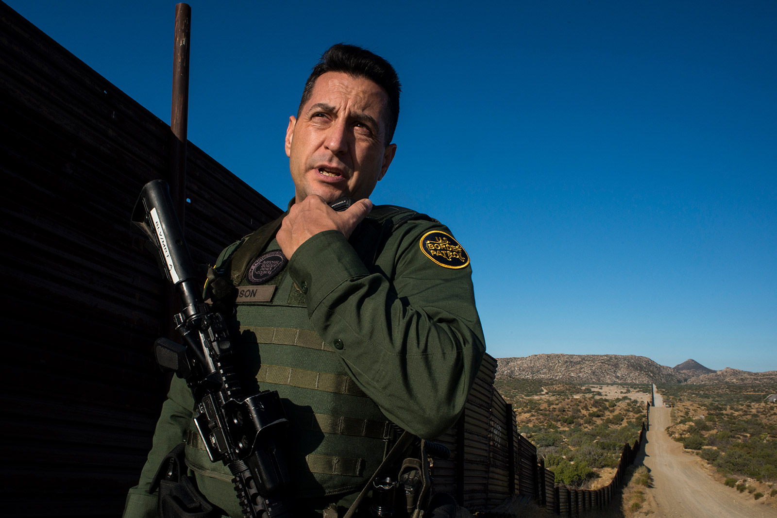 Border Patrol agent Joshua Wilson radios dispatchers to notify them of his location while touring the U.S.-Mexico border near Jacumba in eastern San Diego County on Sept. 5, 2017. <em>(Brandon Quester/inewsource)</em>