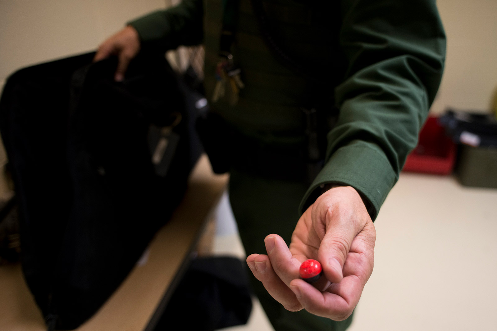 Border Patrol agent Joshua Wilson on Sept. 5, 2017, holds a pepperball, a nonlethal deterrent agents can use while patrolling the U.S.-Mexico border. <em>(Brandon Quester/inewsource)</em>