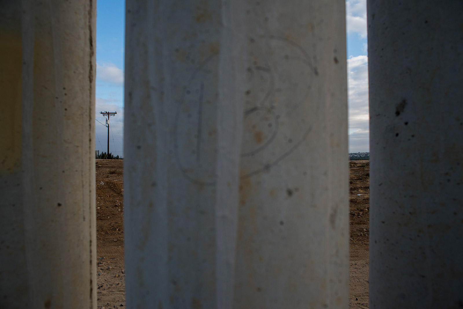 This variation of secondary fencing between the Pacific Ocean and the San Ysidro Port of Entry is made of tall concrete pillars and is topped with metal sheeting. This fencing, shown on Aug. 16, 2017, is designed to stop people and vehicles from entering the U.S. illegally. <em>(Brandon Quester/inewsource)</em>
